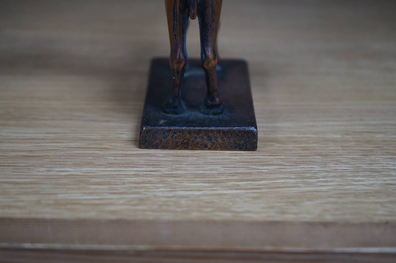 A bronze Royal Air Force 45th Squadron winged camel desk ornament, stamped Reg.746774 to the base